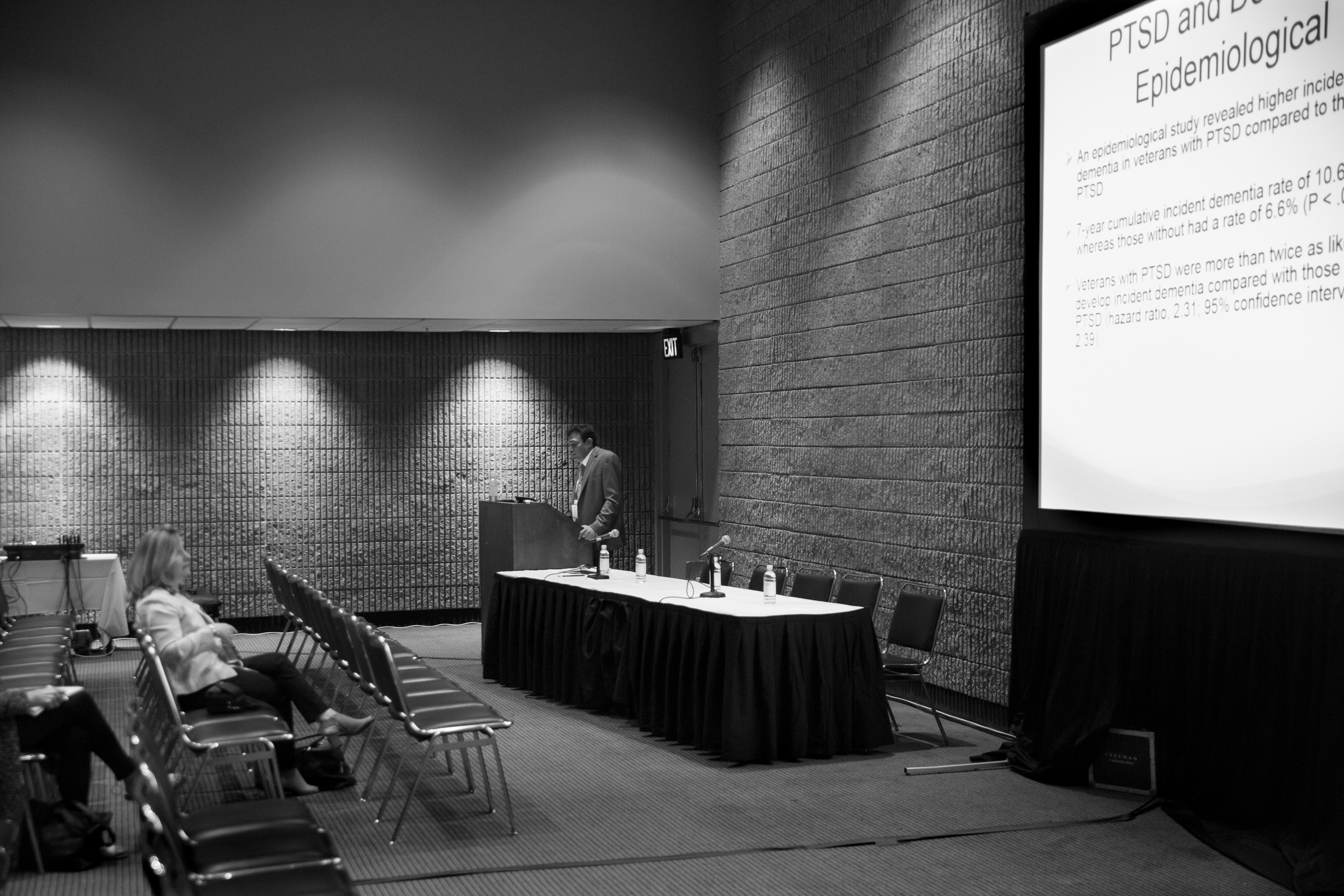 Presenter talks in a conference about depression.